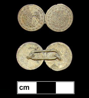 Cast copper alloy buttons with a pinwheel-like floral motif. The center flower is surrounded by emanating rays and two rings of leaves.